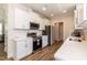 Modern kitchen with white cabinets, quartz countertops, and stainless steel appliances at 438 S Hillsborough St, Franklinton, NC 27525