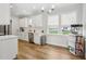 Modern kitchen with white cabinets, quartz countertops, and stainless steel appliances at 438 S Hillsborough St, Franklinton, NC 27525