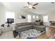 Spacious living room featuring a sectional sofa, large windows, and wood-look flooring at 438 S Hillsborough St, Franklinton, NC 27525
