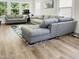 Bright living room with sectional sofa and large windows, showcasing wood-look flooring at 438 S Hillsborough St, Franklinton, NC 27525