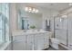 Main bathroom with double vanity, shower, and white cabinets at 445 Brier Summit Pl, Durham, NC 27703