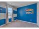 bedroom with blue walls, window, and built-in shelving at 445 Brier Summit Pl, Durham, NC 27703