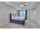 Main bedroom with blue bed frame, carpet, ceiling fan, and window at 445 Brier Summit Pl, Durham, NC 27703