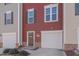 Townhome exterior featuring a red and beige facade at 445 Brier Summit Pl, Durham, NC 27703