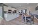Open kitchen features island, granite countertops, stainless steel appliances and flows into dining area at 445 Brier Summit Pl, Durham, NC 27703