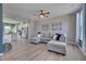 Spacious living room with L-shaped sofa, hardwood floors, and view into kitchen at 445 Brier Summit Pl, Durham, NC 27703