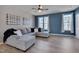 Bright living room with L-shaped sofa, hardwood floors and blue accent wall at 445 Brier Summit Pl, Durham, NC 27703