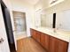 Bathroom with double vanity, a large mirror, and access to a tiled walk-in shower at 4712 Fox Fern Ln, Raleigh, NC 27604