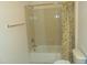 Clean bathroom with shower/tub combo, toilet, and vanity with wood cabinets at 4712 Fox Fern Ln, Raleigh, NC 27604