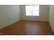 Bright bedroom with hardwood floors and a window with blinds at 4712 Fox Fern Ln, Raleigh, NC 27604