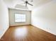 Spacious bedroom with hardwood floors, a ceiling fan, and a window at 4712 Fox Fern Ln, Raleigh, NC 27604
