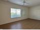 Bedroom featuring hardwood floors, a ceiling fan, and a large window at 4712 Fox Fern Ln, Raleigh, NC 27604