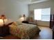 Cozy bedroom with floral bedding and large window at 4712 Fox Fern Ln, Raleigh, NC 27604