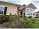 Exterior of home with a brick and tan color scheme and a sunroom addition at 4712 Fox Fern Ln, Raleigh, NC 27604