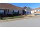Tan brick home with a sunroom and attached garage at 4712 Fox Fern Ln, Raleigh, NC 27604