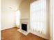 Cozy room featuring a fireplace with white mantel and wood floors at 4712 Fox Fern Ln, Raleigh, NC 27604