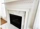 Close up shot of the fireplace with marble hearth and white mantel at 4712 Fox Fern Ln, Raleigh, NC 27604