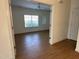 Bright living room with wood floors, large window, and ceiling fan at 4712 Fox Fern Ln, Raleigh, NC 27604