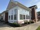 Bright sunroom addition with large windows and brick exterior and colorful landscaping at 4712 Fox Fern Ln, Raleigh, NC 27604