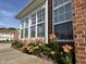 The sunroom features large windows and a vibrant flower garden at 4712 Fox Fern Ln, Raleigh, NC 27604