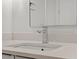 Close-up of a modern sink with a quartz countertop, stylish faucet, and a large mirror in the bathroom at 523 S West # 305, Raleigh, NC 27601