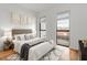 Cozy bedroom with large windows, modern decor, and hardwood floors at 523 S West # 305, Raleigh, NC 27601