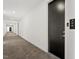 Apartment hallway with carpet and a dark-colored door labeled 305 at 523 S West # 305, Raleigh, NC 27601