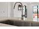 Close-up of a modern kitchen sink featuring modern faucet and countertops at 523 S West # 305, Raleigh, NC 27601