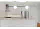 Bright, open kitchen with stainless appliances, modern lighting, and light countertops at 523 S West # 305, Raleigh, NC 27601