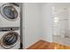 Laundry closet featuring a stackable washer and dryer and a view into the nearby bathroom at 523 S West # 305, Raleigh, NC 27601