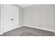 Simple bedroom with gray walls, carpet and double door closet at 621 Coleman St, Raleigh, NC 27610