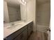 Bathroom featuring double sink vanity, quartz countertops and combination tub with shower at 6328 Granite Quarry Dr, Raleigh, NC 27610