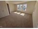 A bedroom with natural light has neutral walls, carpet, and views of the neighborhood through the windows at 6328 Granite Quarry Dr, Raleigh, NC 27610