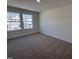 Sunlit bedroom features plush carpeting and large windows with views of the neighborhood at 6328 Granite Quarry Dr, Raleigh, NC 27610