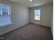 Bright bedroom offers plush carpet and lots of natural light from dual windows at 6328 Granite Quarry Dr, Raleigh, NC 27610
