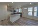 Modern kitchen with gray cabinets, granite countertops, stainless appliances and island at 6328 Granite Quarry Dr, Raleigh, NC 27610