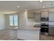 Bright kitchen with ample counter space, gray cabinetry, and stainless steel appliances at 6328 Granite Quarry Dr, Raleigh, NC 27610