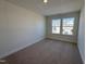 Bedroom with carpet and large windows overlooking neighborhood at 6330 Granite Quarry Dr, Raleigh, NC 27610