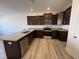 Kitchen features granite counters, stainless appliances and sleek, dark cabinetry at 6330 Granite Quarry Dr, Raleigh, NC 27610