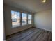 Bright living room with large windows and wood-look flooring at 6330 Granite Quarry Dr, Raleigh, NC 27610