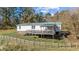 Large deck, wooden fence, and view of woods at 754 Firestone Ln, Sanford, NC 27330