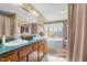 Relax in this bathroom with dual sinks and a large garden tub at 754 Firestone Ln, Sanford, NC 27330