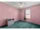Bedroom with green carpet and a gray media cabinet at 754 Firestone Ln, Sanford, NC 27330