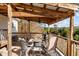 Enjoy the view from this covered deck with seating area at 754 Firestone Ln, Sanford, NC 27330