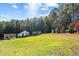 Open farmland with multiple outbuildings visible at 754 Firestone Ln, Sanford, NC 27330