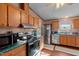 Kitchen offers ample counter space, stainless steel appliances, and wood cabinets at 754 Firestone Ln, Sanford, NC 27330