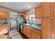 Kitchen with wood cabinets, stainless steel appliances and a view of the living room at 754 Firestone Ln, Sanford, NC 27330