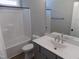 Bathroom with vanity, bathtub and shower combo, toilet and neutral wall color at 104 Halifax Rd, Louisburg, NC 27549