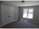 Bedroom with carpet flooring, window, closet and neutral colored walls at 104 Halifax Rd, Louisburg, NC 27549