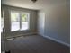 Neutral bedroom featuring a window with beautiful views and carpet flooring at 104 Halifax Rd, Louisburg, NC 27549